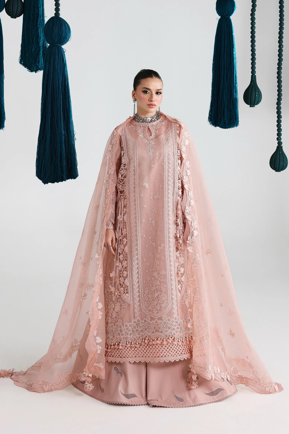 Model wearing an intricately embroidered Silk and Stone formal Pakistani outfit